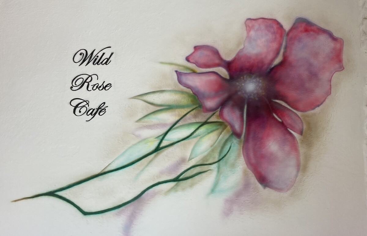 Wild Rose Cafe logo with a painting of a rose